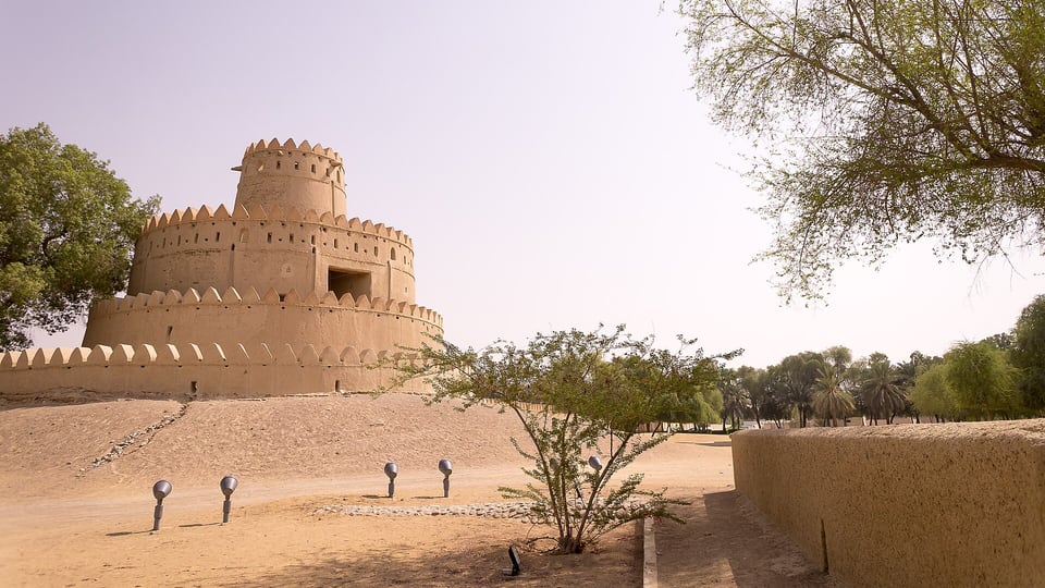 The crenellated mud-brick tower of Al Jahili Fort in Al Ain