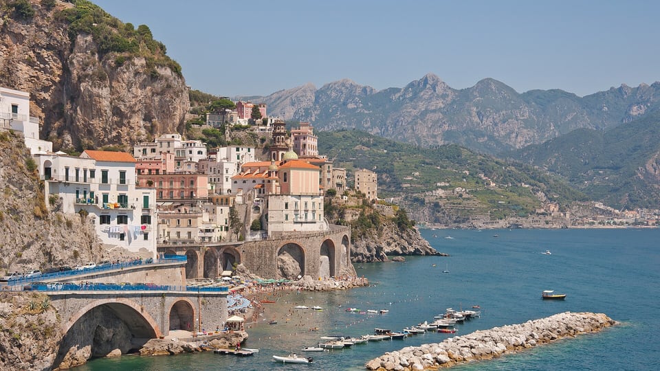 The village of Atrani packed into its small bay beside the coastal road arches