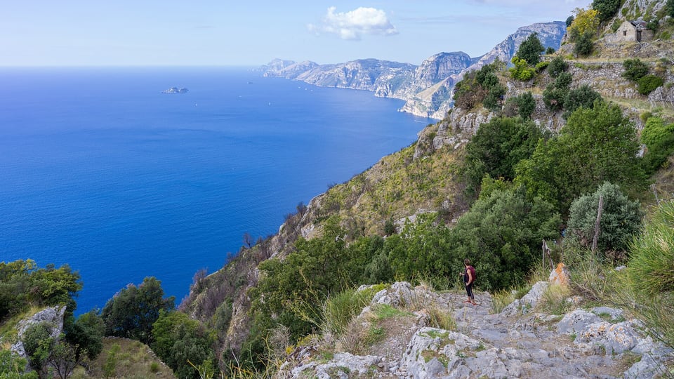 The Path of the Gods trail on a cliffside high above the sea, looking west toward Capri