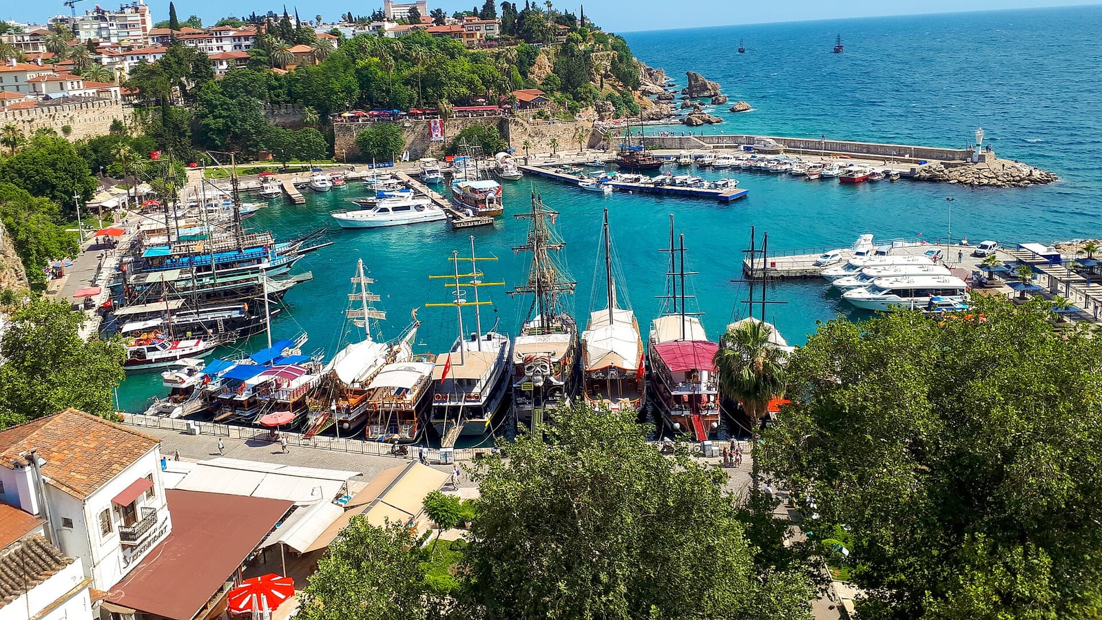Antalya old harbour, boats and Mediterranean cliffs seen from Kaleiçi