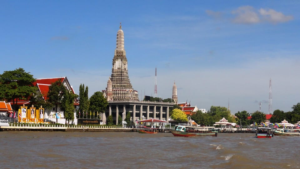 Wat Arun's central prang seen across the Chao Phraya River in Bangkok