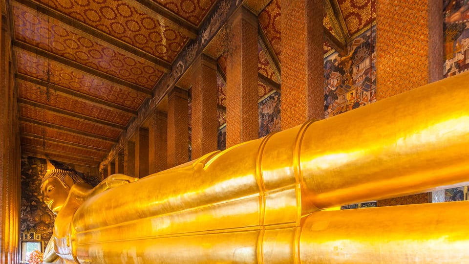 The gilded Reclining Buddha stretching the length of its hall at Wat Pho in Bangkok