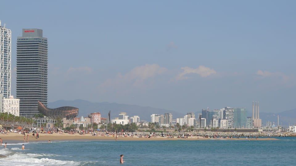Barceloneta beach and the Mediterranean with the Hotel Arts tower and waterfront skyline behind