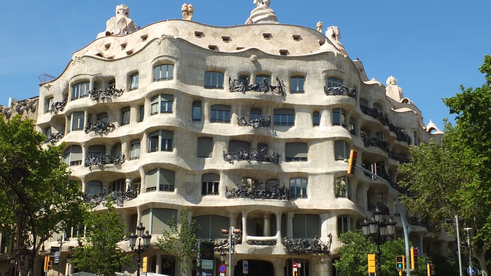 The undulating stone facade and iron balconies of La Pedrera (Casa Milà) in Barcelona