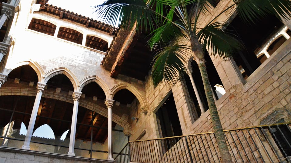 Arcaded Gothic gallery and palm in a palace courtyard of the Museu Picasso in Barcelona