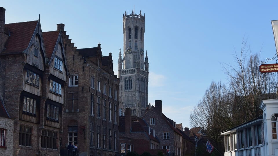 The Rozenhoedkaai canal view of the Belfry of Bruges, a day trip from Brussels