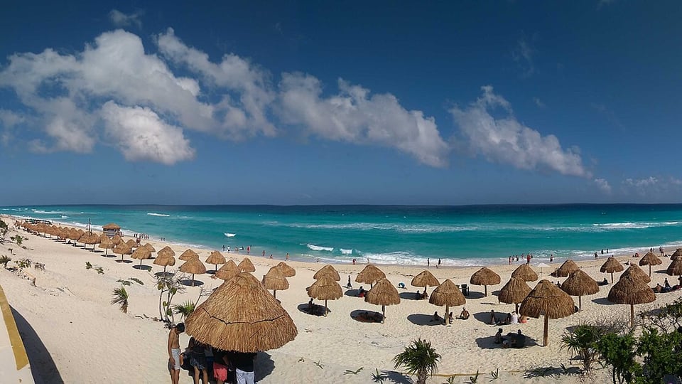 Palapas and Caribbean surf at Playa Delfines