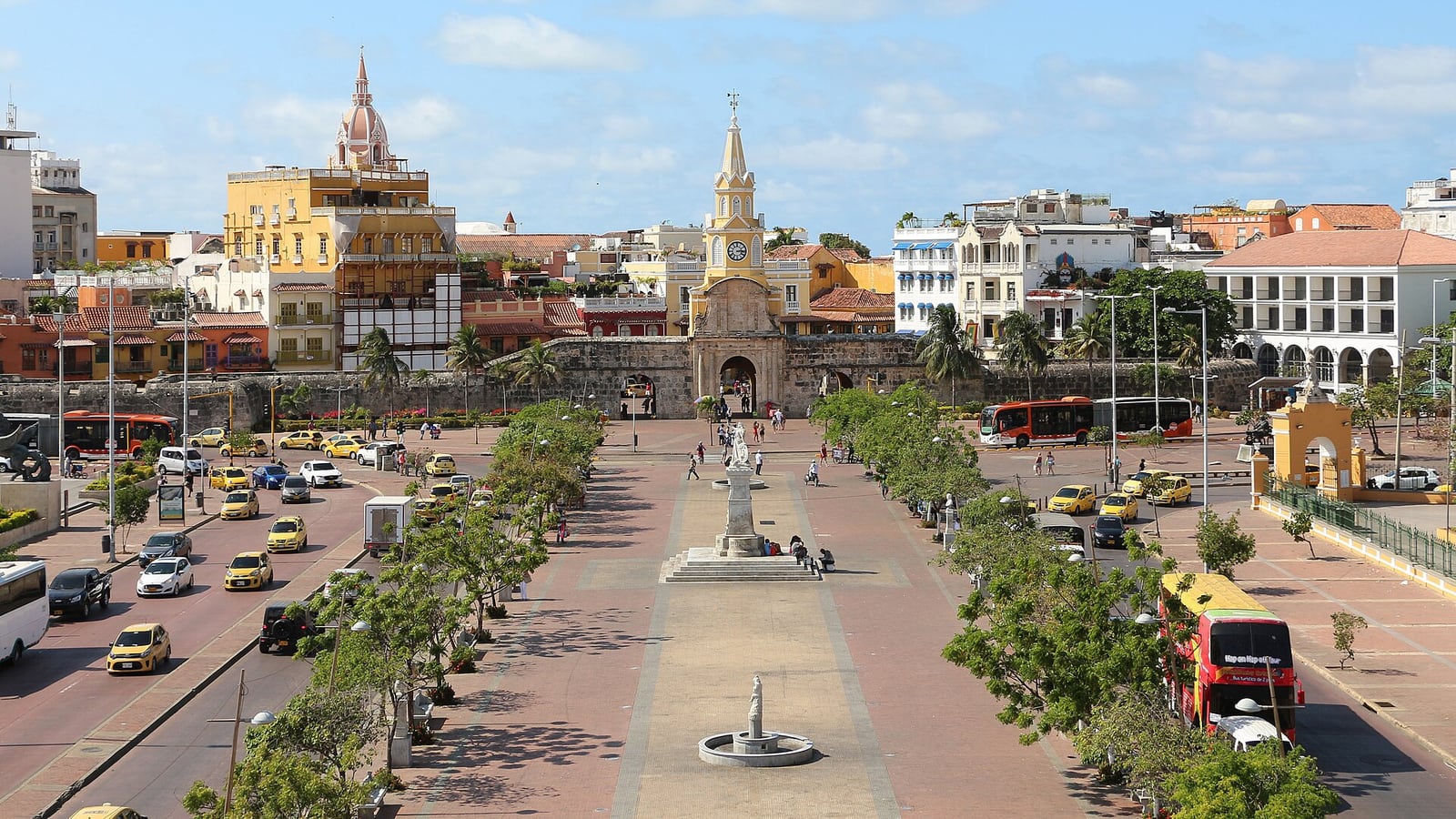 The Puerta del Reloj clock gate at the end of a palm-lined boulevard in Cartagena, Colombia