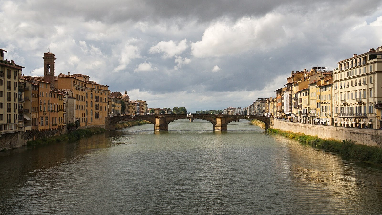 The Arno and Ponte Santa Trinita between rows of riverside buildings in Florence