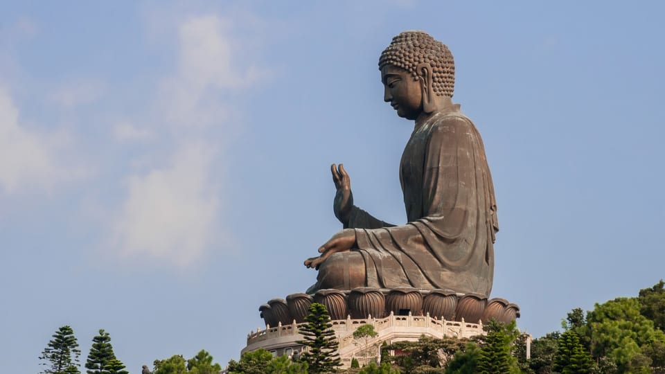 The bronze Tian Tan Buddha seated on its hilltop platform at Ngong Ping on Lantau Island