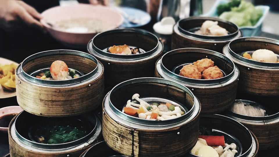 Bamboo steamer baskets of dim sum on a breakfast table in Hong Kong