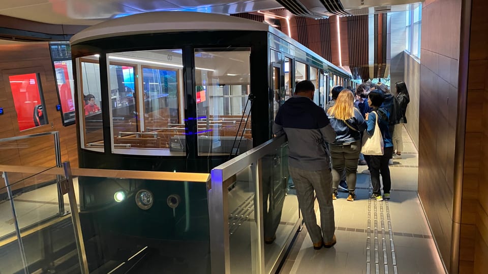 A current-generation Peak Tram car waiting at the platform of the Peak Tram terminus on Victoria Peak