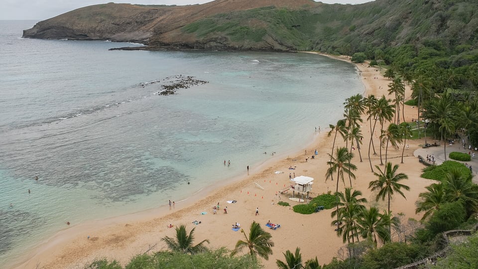 The curved beach and reef of Hanauma Bay inside its crater rim