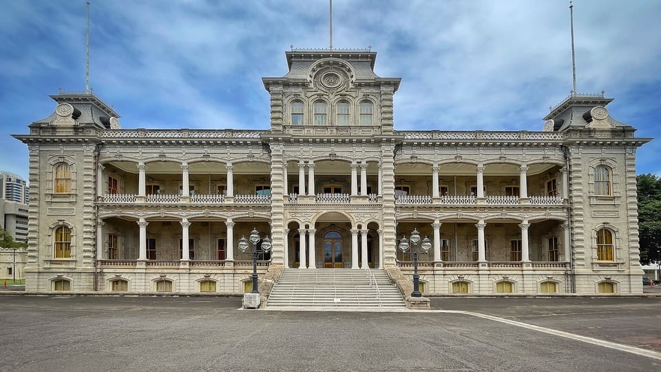 The front of ʻIolani Palace with its verandas and towers across the palace grounds