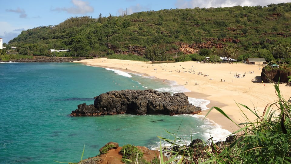 The golden beach and turquoise water of Waimea Bay on the North Shore