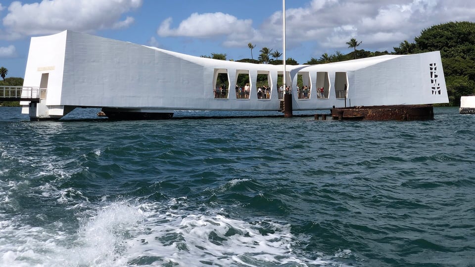 The white USS Arizona Memorial seen from the ferry boat crossing Pearl Harbor