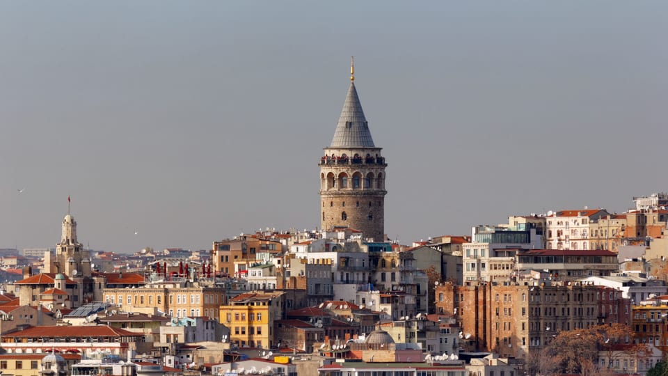 Galata Tower's conical roof rising above the hillside buildings of Galata, Istanbul