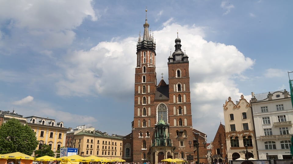 The twin Gothic towers of St. Mary’s Basilica on the Main Market Square, from which the hourly Hejnał trumpet call is played