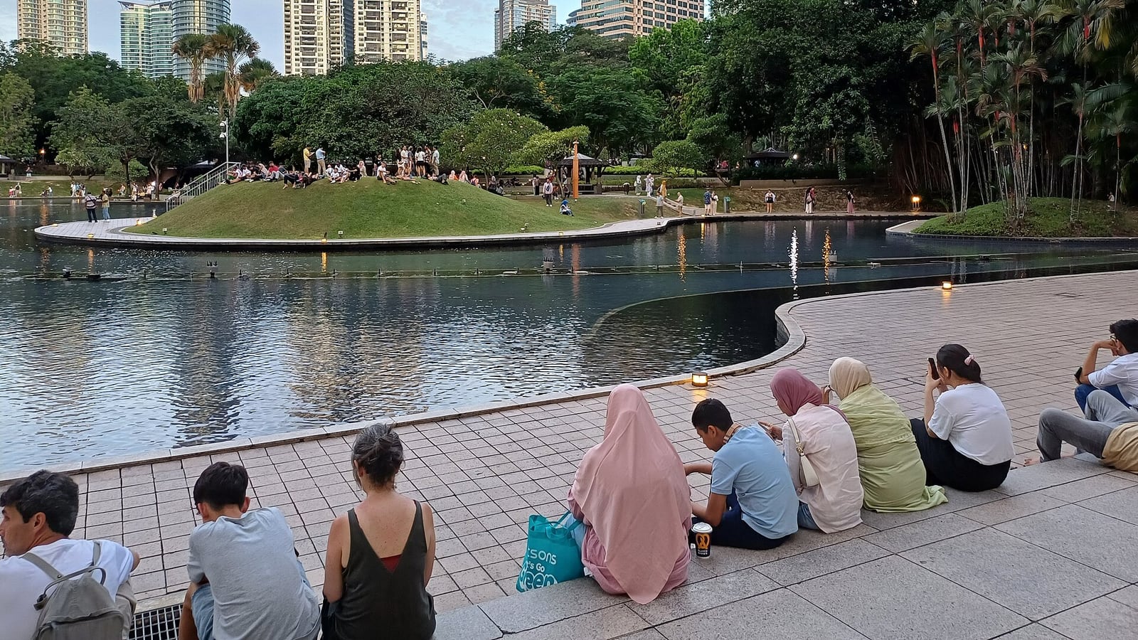 KLCC Park lawns and lake beneath Kuala Lumpur towers