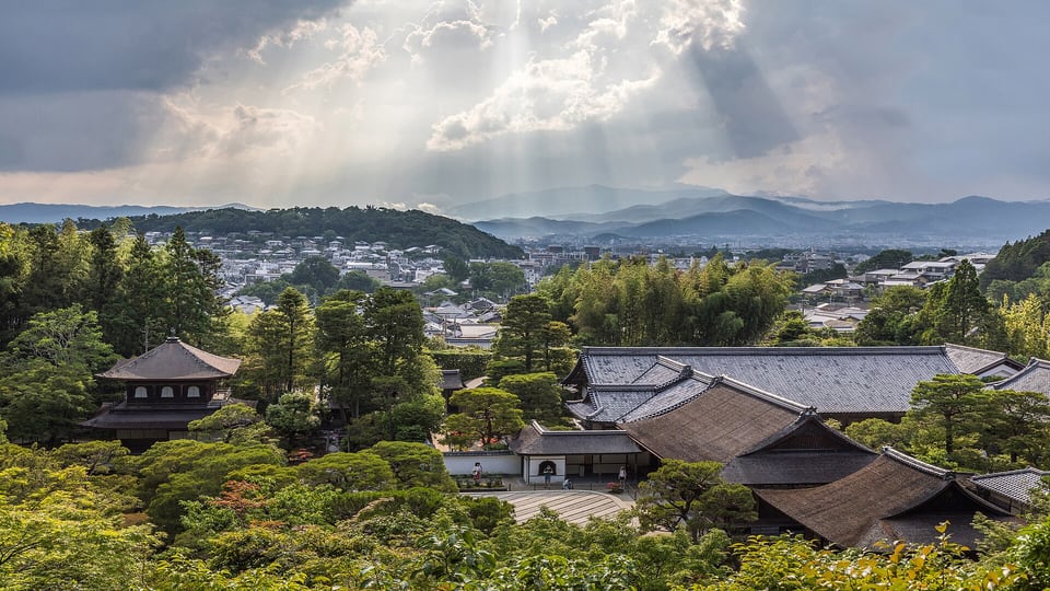 Ginkaku-ji and its Togudo hall seen from the hillside path with the city and mountains beyond