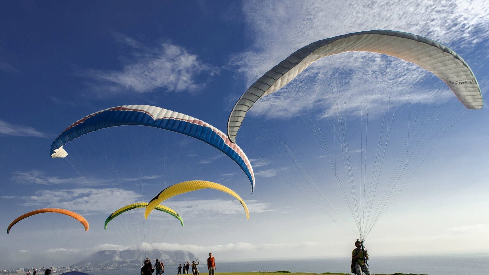 Paragliders taking off from the clifftop park in Miraflores, Lima, above the Pacific