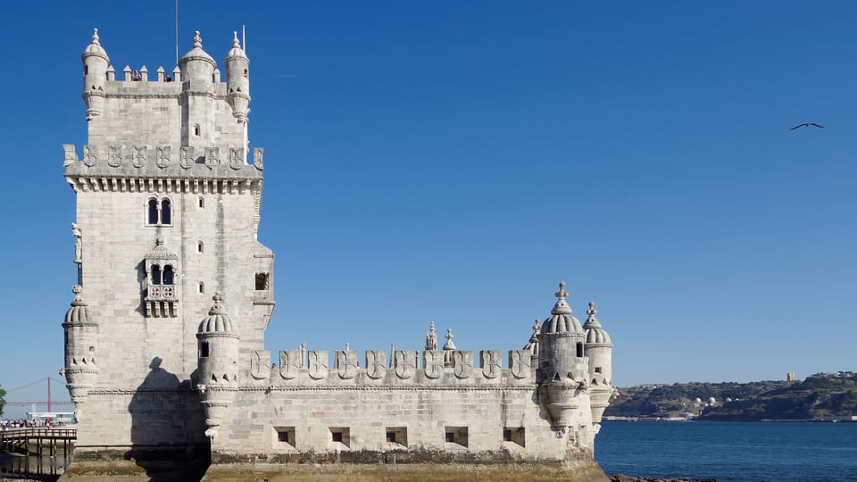 Belém Tower, the carved limestone fortified tower on the Tagus in Lisbon, under a clear sky