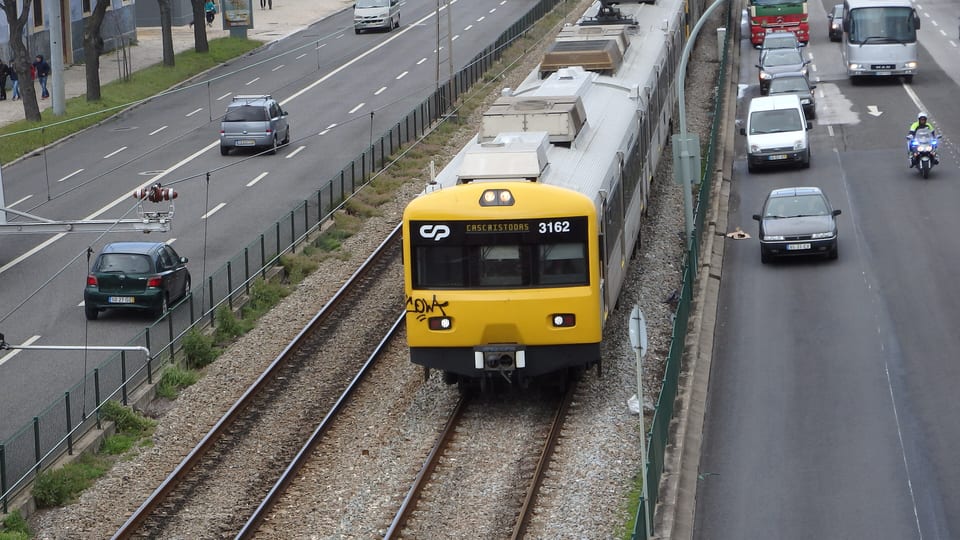 A suburban train heading towards Cascais on the Cascais railway line in Belém, Lisbon