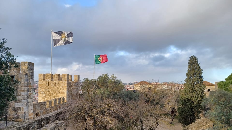 Battlements and flags on the walls of São Jorge Castle above Lisbon