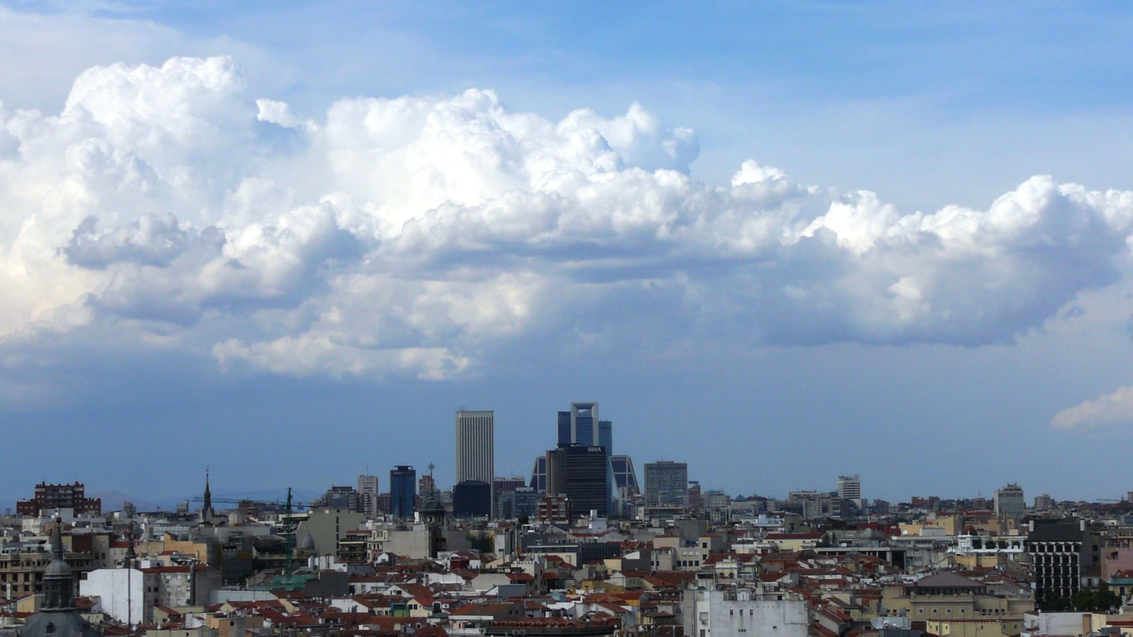 Madrid skyline beneath summer clouds