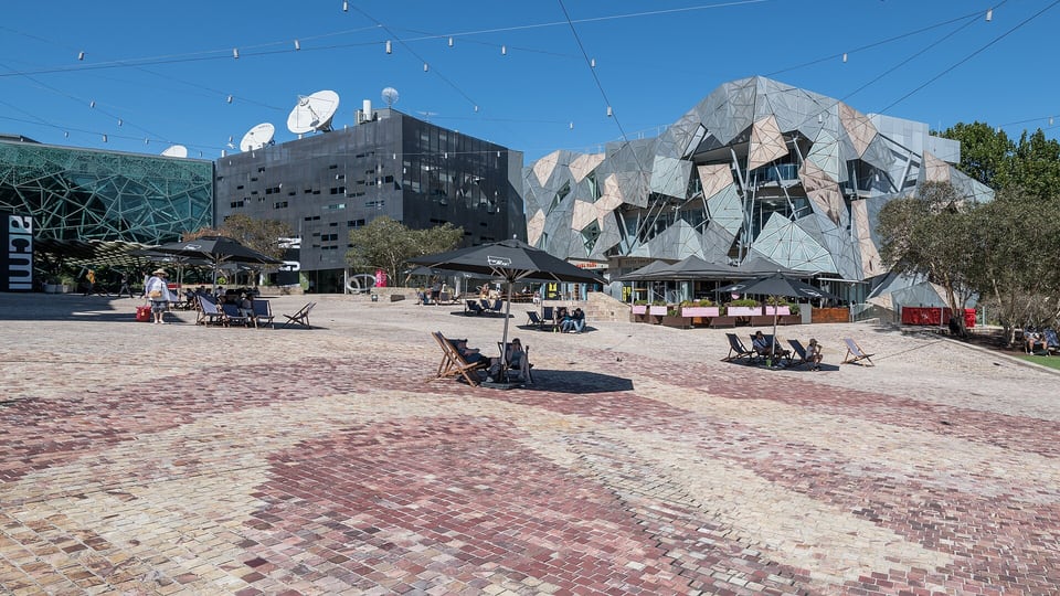 Federation Square’s angular building facades around its brick-paved square