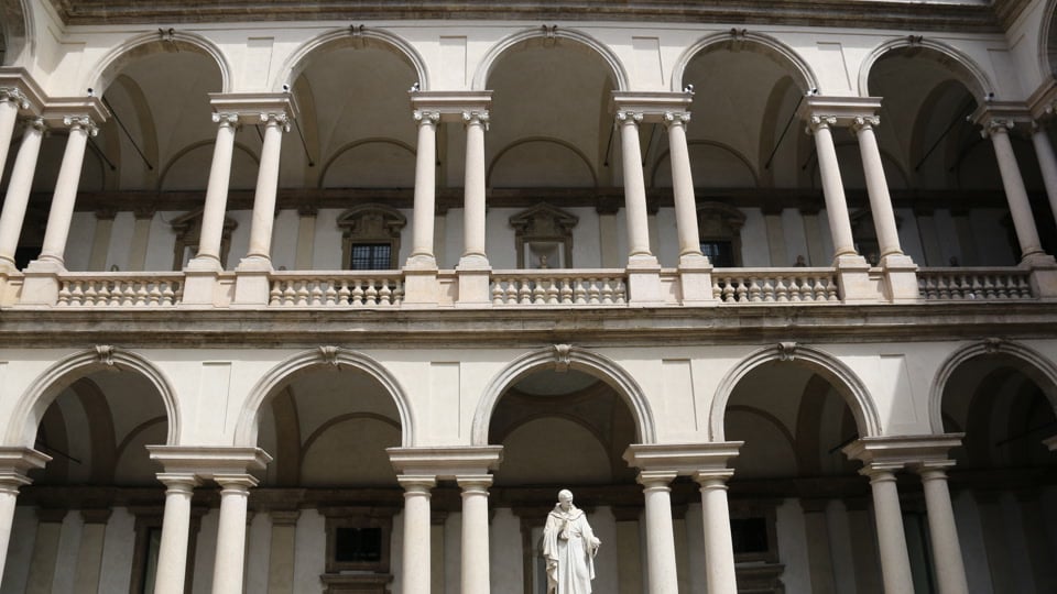 The courtyard of Milan's Pinacoteca di Brera with its arcades and statue