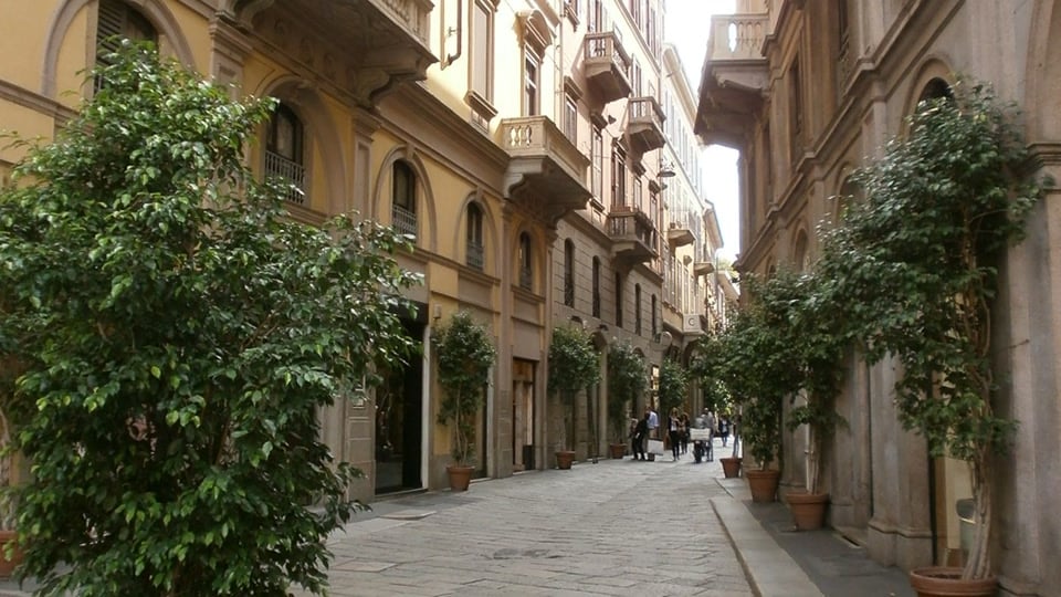 Via della Spiga in Milan's Quadrilatero della Moda, lined with elegant buildings and trees