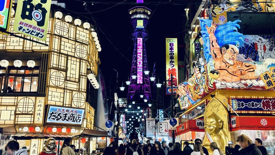 Tsutenkaku tower above the lit streets of Shinsekai after dark