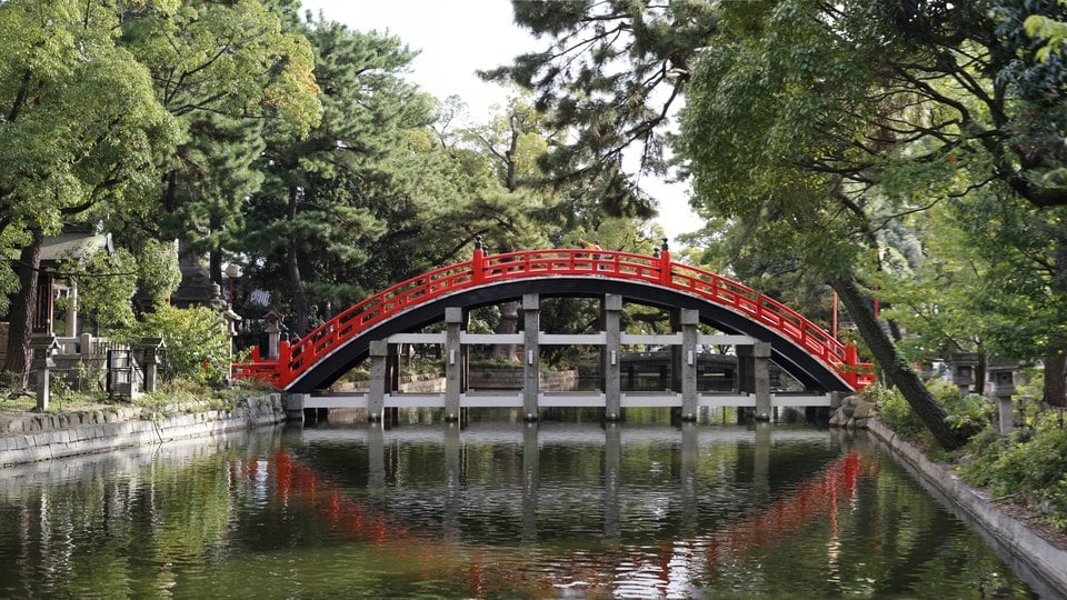 The red Sorihashi bridge over water at Sumiyoshi Taisha