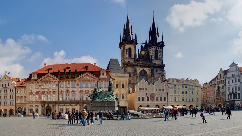 Old Town Square in Prague with the twin spires of the Church of Our Lady before Týn and the Jan Hus Memorial