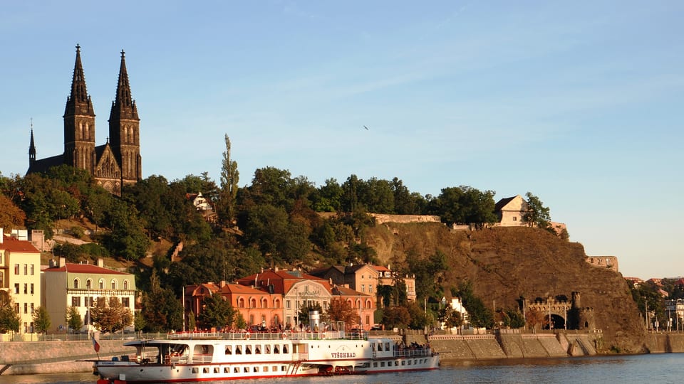 The twin spires of the Basilica of St Peter and St Paul above the Vyšehrad rock and ramparts, seen across the Vltava