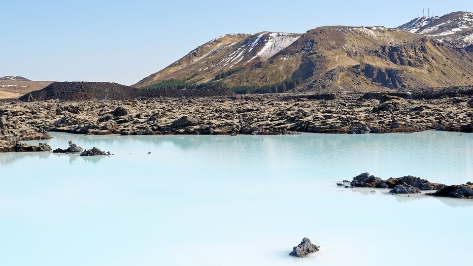 The Blue Lagoon’s milky-blue geothermal water with Þorbjörn mountain behind it