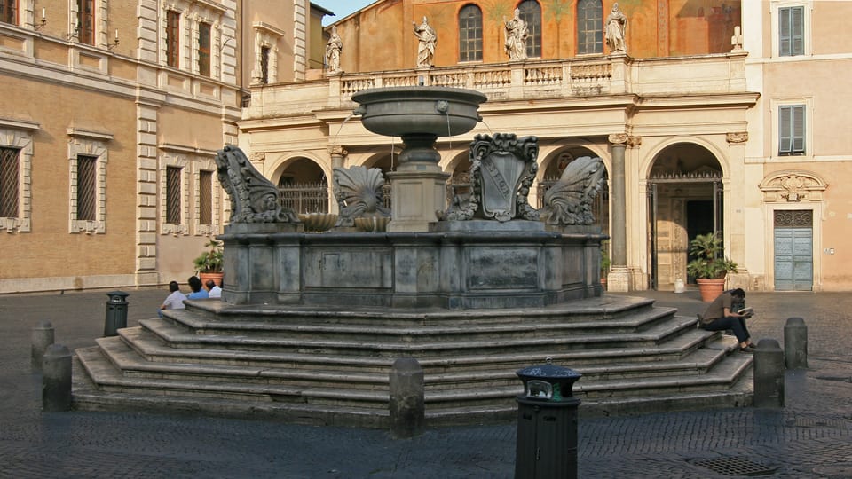 The fountain on Piazza di Santa Maria in Trastevere in Rome, in front of the portico of the Basilica of Santa Maria in Trastevere