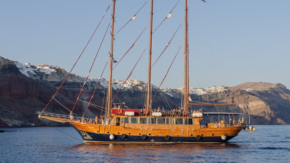 A tour boat sailing the caldera near Oia