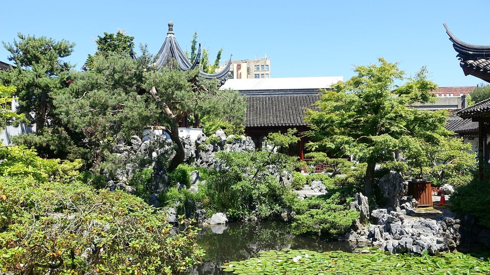 Pond, rockery and pavilion roofs inside the Dr. Sun Yat-Sen Classical Chinese Garden