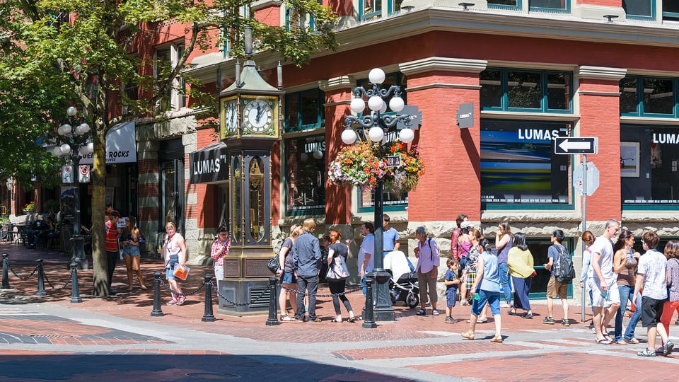 The Gastown steam clock on a Water Street corner beside red-brick heritage buildings