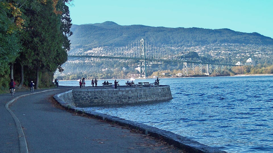 Stanley Park seawall path with the Lions Gate Bridge beyond the water