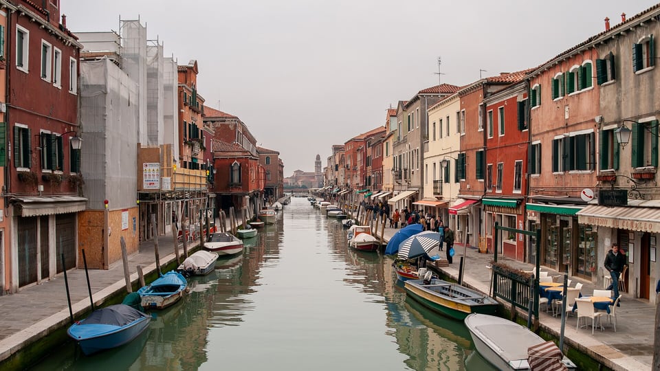 The Rio dei Vetrai canal on Murano lined with houses and moored boats
