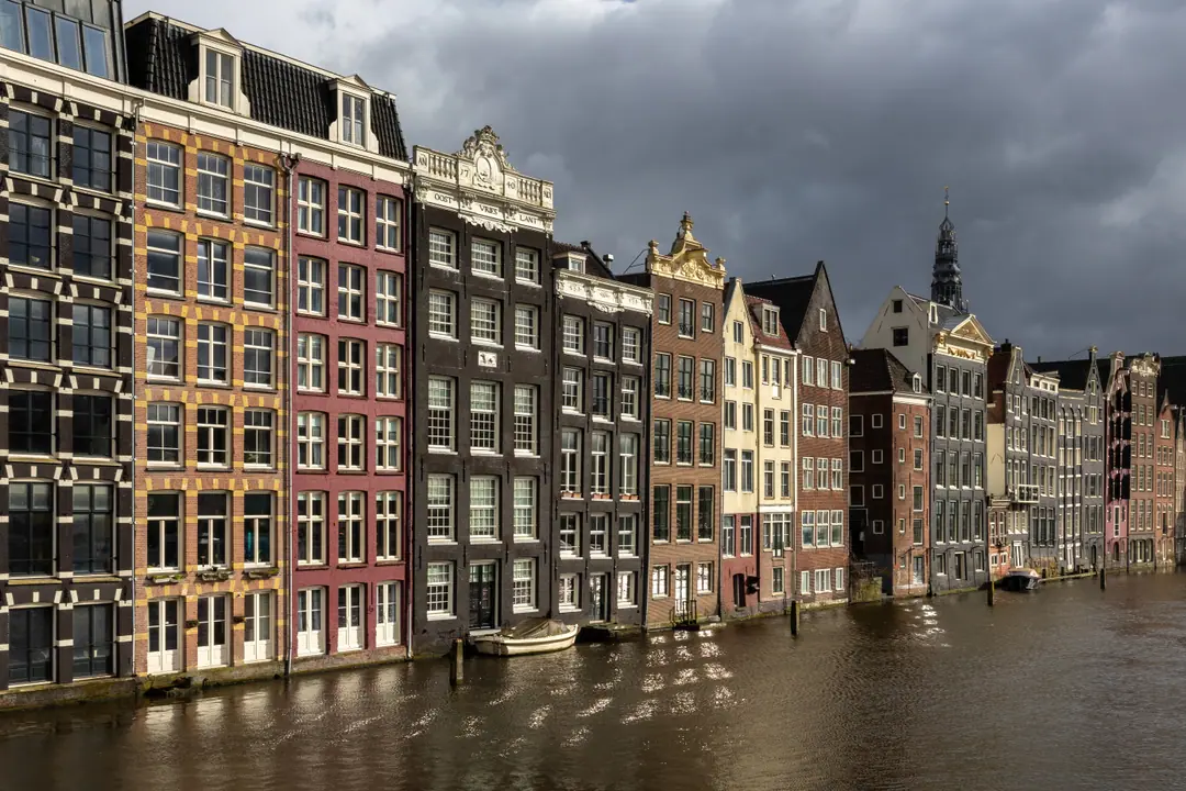 Canal houses along Damrak in Amsterdam's historic centre at golden hour